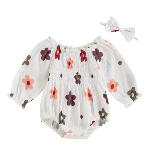 Floral-patterned baby romper with matching headband on a white background