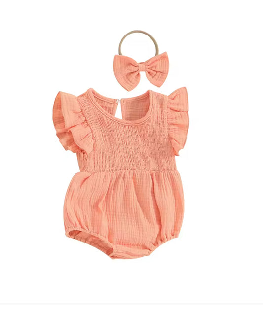 Peach-colored baby romper with ruffled sleeves and matching headband on a white background