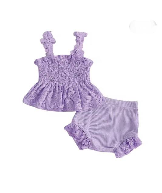 Purple baby outfit with top and bloomers on a white background