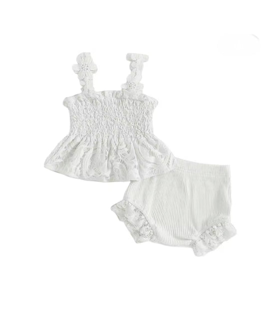 White baby romper set with ruffled top and bloomers on a white background