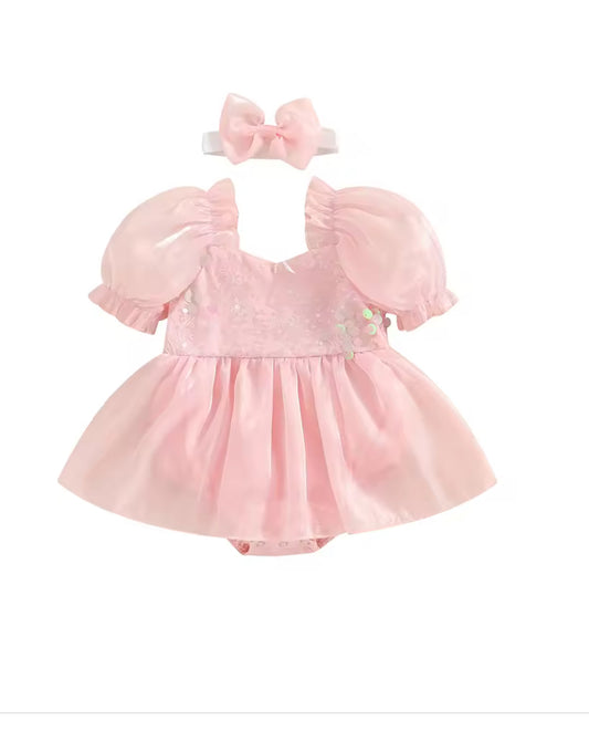 Pink baby dress with matching headband on a white background