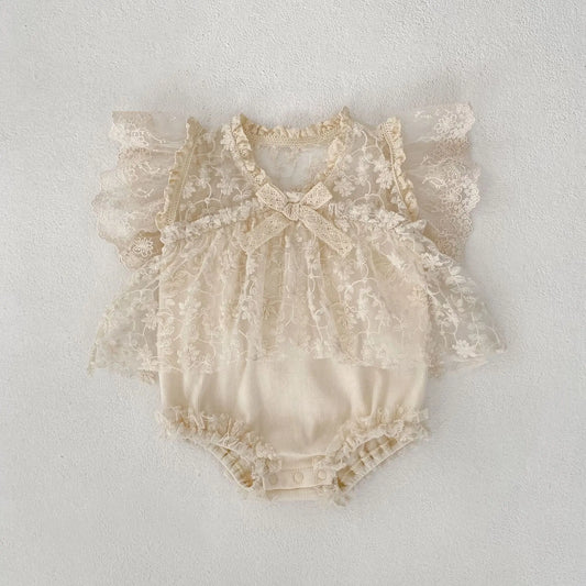 Beige lace baby romper on a light gray background