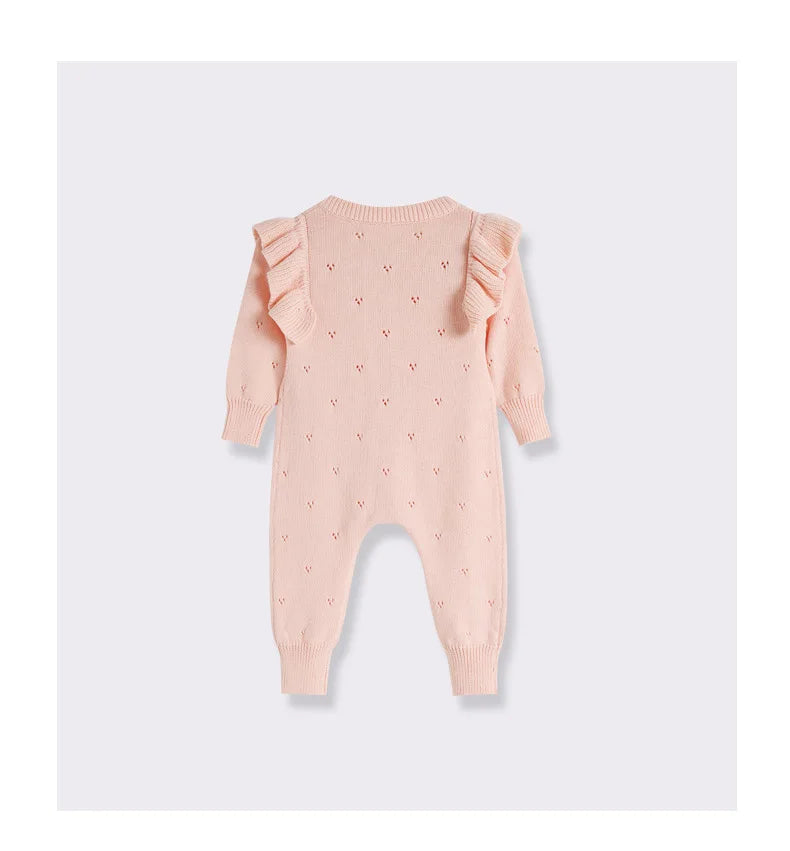 Pink baby romper with ruffled sleeves on a white background