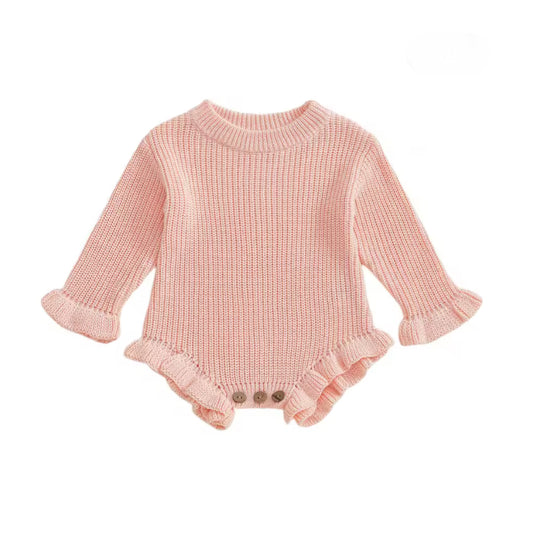 Pink knitted baby romper with ruffled details on a white background