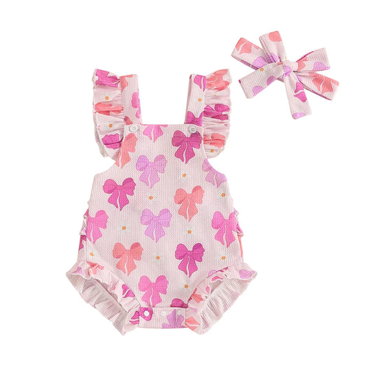 Baby romper with pink bows and matching headband on a white background