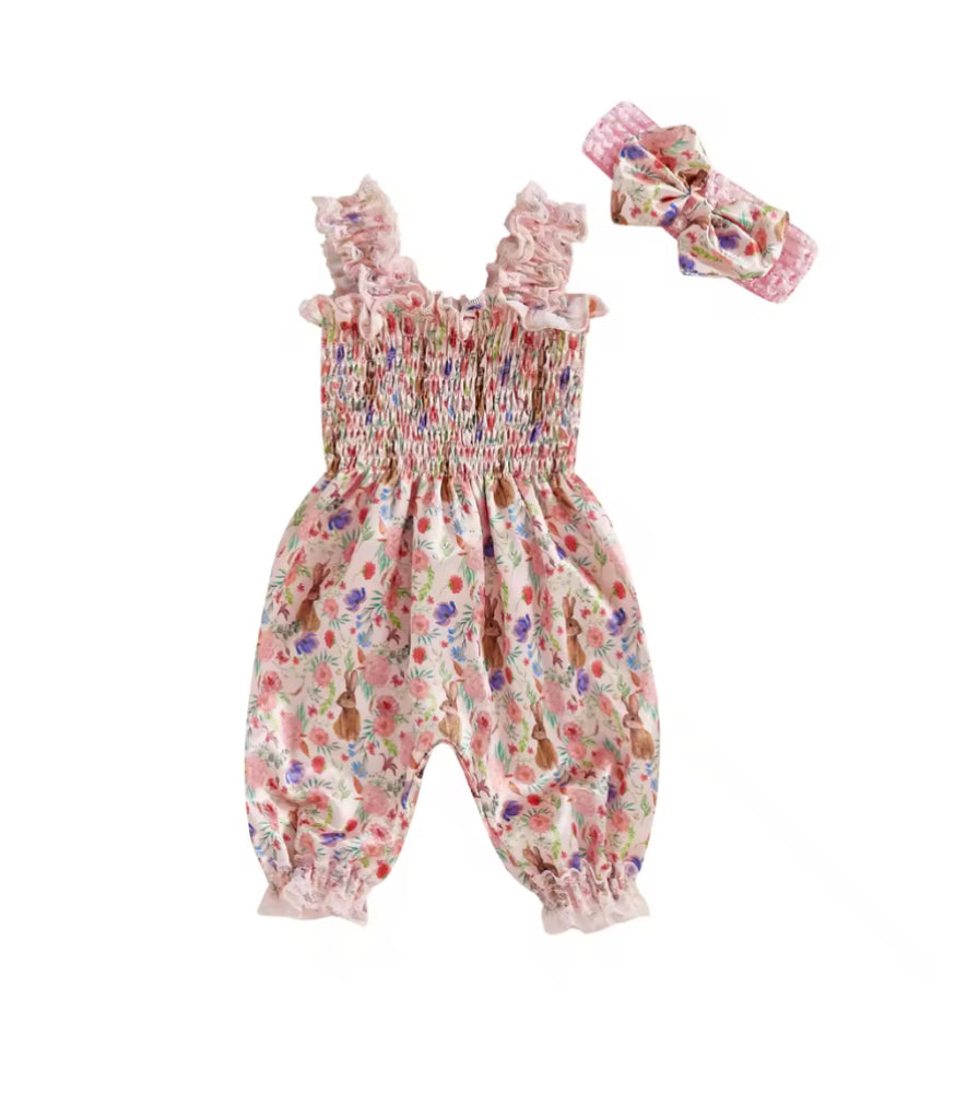 Floral baby romper with matching headband on a white background