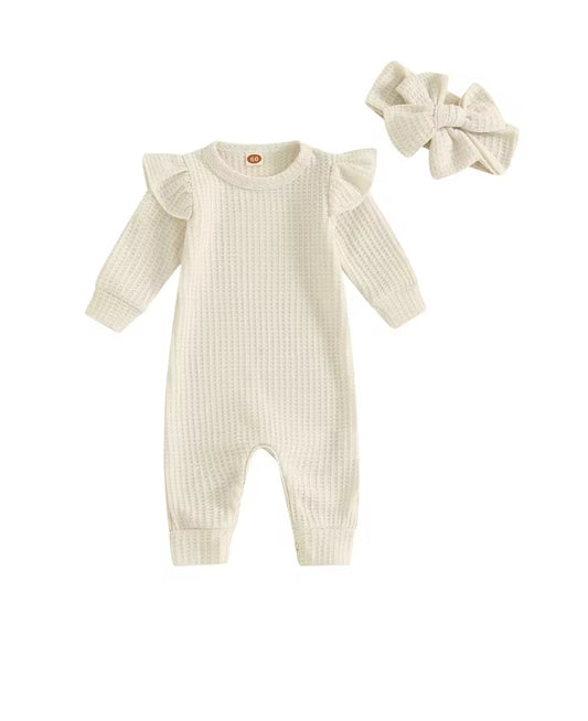 White ribbed baby romper with ruffled sleeves and matching headband on a white background