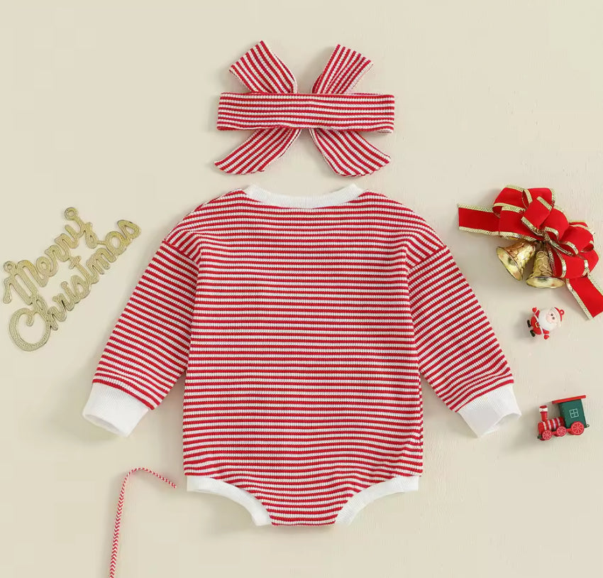 Red and white striped baby romper with matching headband on a beige background