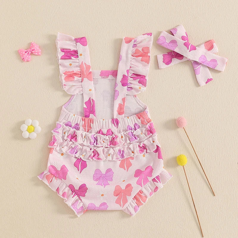 Children's floral romper with ruffles and matching headband on a beige background