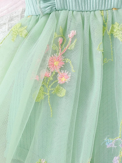 Green tulle skirt with floral embroidery on a light background