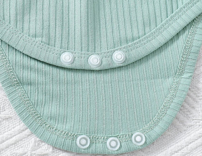 Close-up of a light blue fabric with buttons on a textured surface