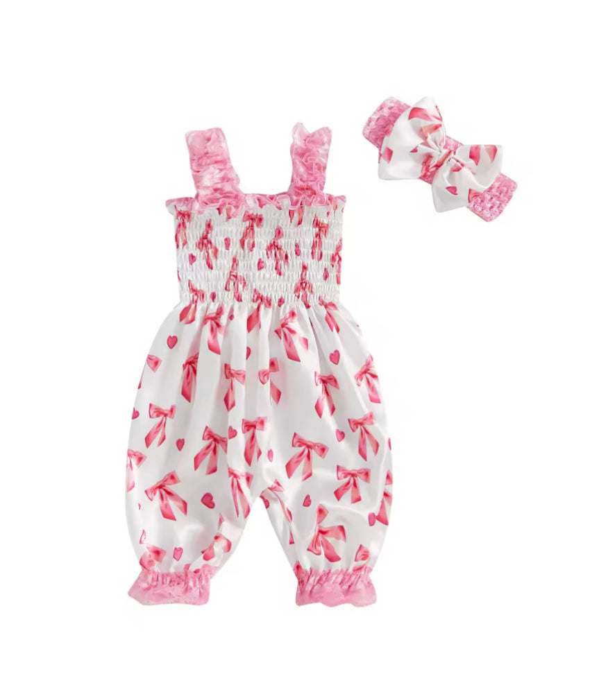 Baby romper with pink floral pattern and matching headband on a white background