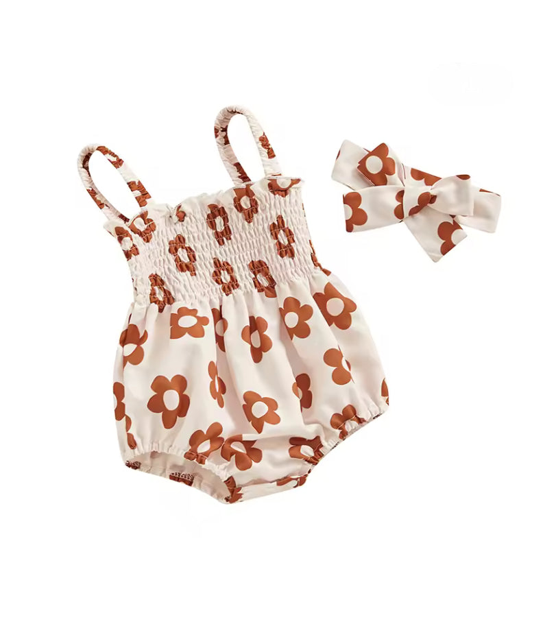 Floral baby romper with matching headband on a white background