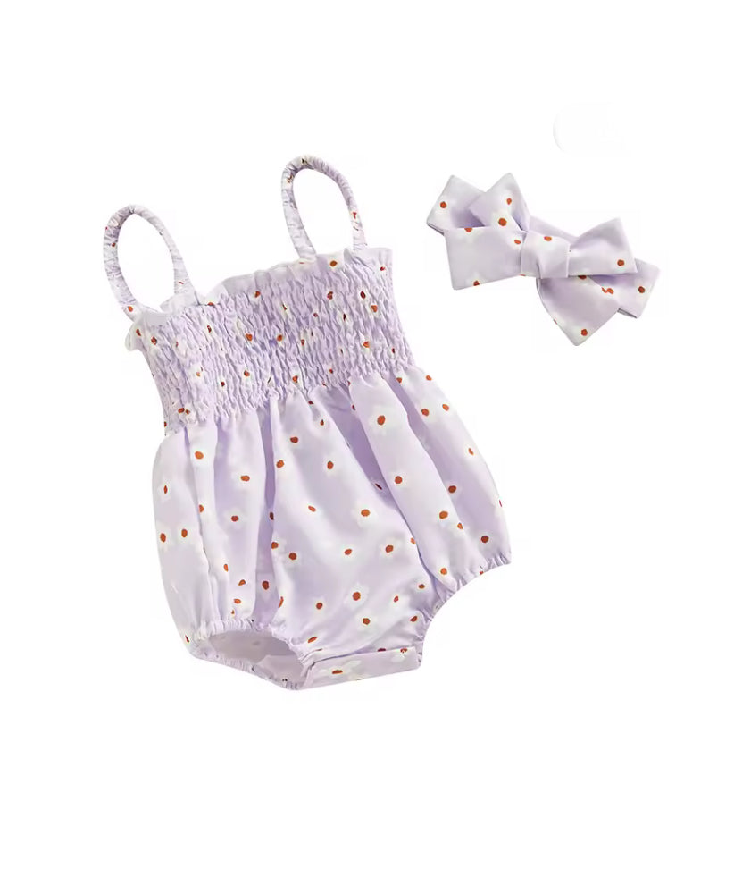 Baby romper with daisy pattern and matching headband on a white background