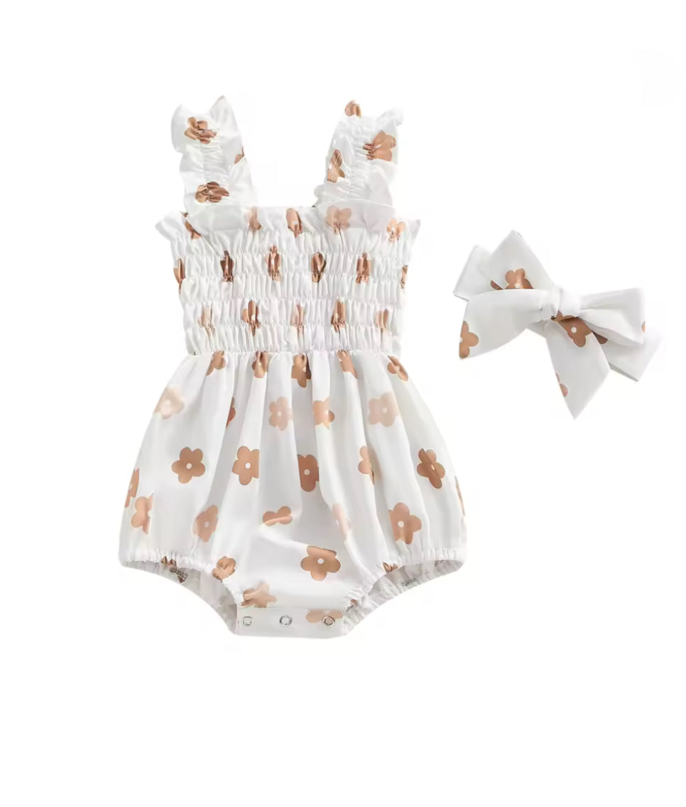 Baby romper with floral pattern and matching headbands on a white background