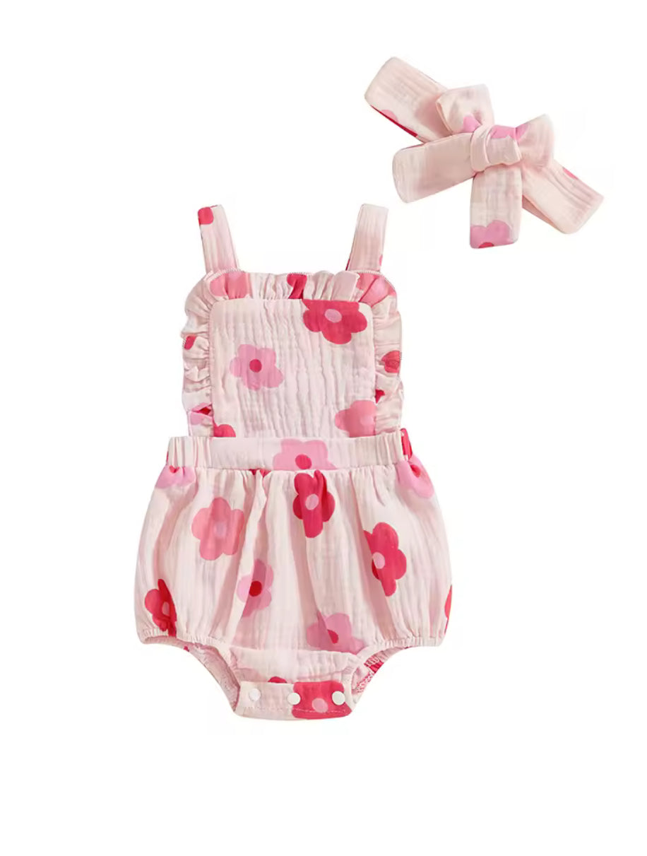 Baby romper with floral pattern and matching headband on a white background