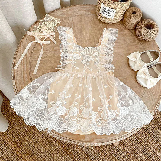 Lace dress on a wooden table with ribbons and shoes