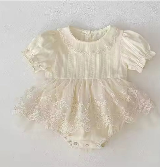 White lace baby dress on a light gray background