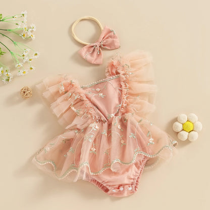 Baby boho - baby girls clothing -Pink baby romper with floral details and matching headband on a beige background