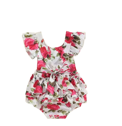 Floral baby romper with ruffles on a white background