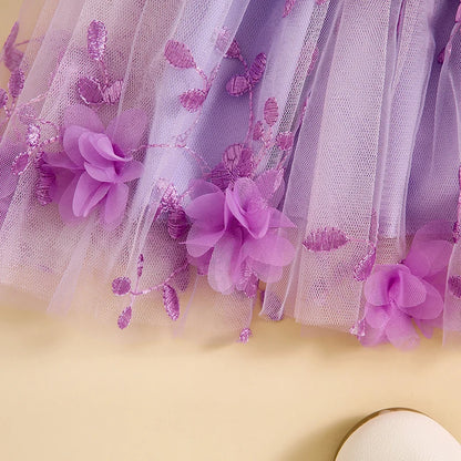 Close-up of a purple floral dress with tulle on a yellow background