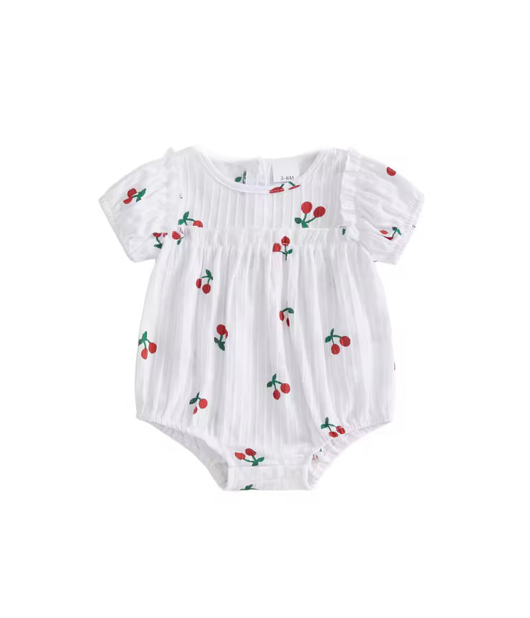 White baby romper with cherry pattern on a white background