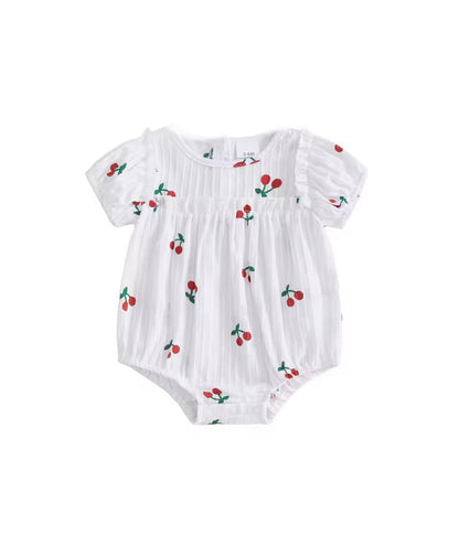 White baby romper with cherry pattern on a white background