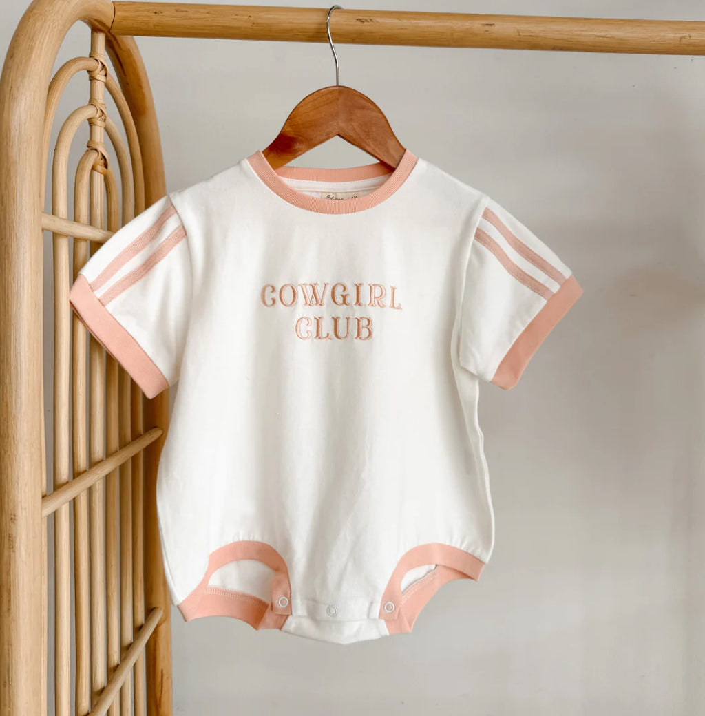 Baby romper with 'Cowgirl Club' text on a hanger against a neutral background blossom and pear found in Baby Boho,Store,