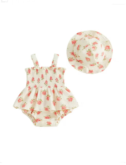 A baby girl's two-piece outfit set featuring a ruffled sleeveless romper and a matching wide-brim sun hat, both in a cream fabric with a pink and green floral print, shown on a plain white background.
